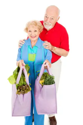 Green shoppers with eco friendly shopping bags filled with groceries