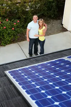 A couple admiring their new solar panels on the roof