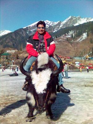 Me riding a Yak in Manali, India, with the backdrop of the Himalayas behind me. I hope they can survive the forces of climate change!